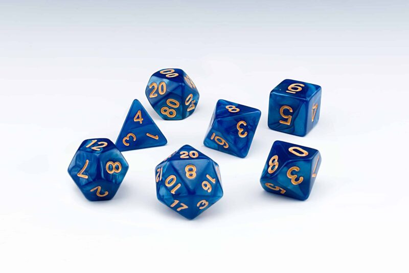 Abyss Dark blue pearlescent set of 7 RPG dice with Gold numbers from Northumbrian Tin Soldier on a white background