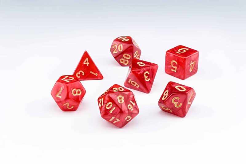 Candescence red pearlescent set of 7 RPG dice with Gold numbers from Northumbrian Tin Soldier on a white background